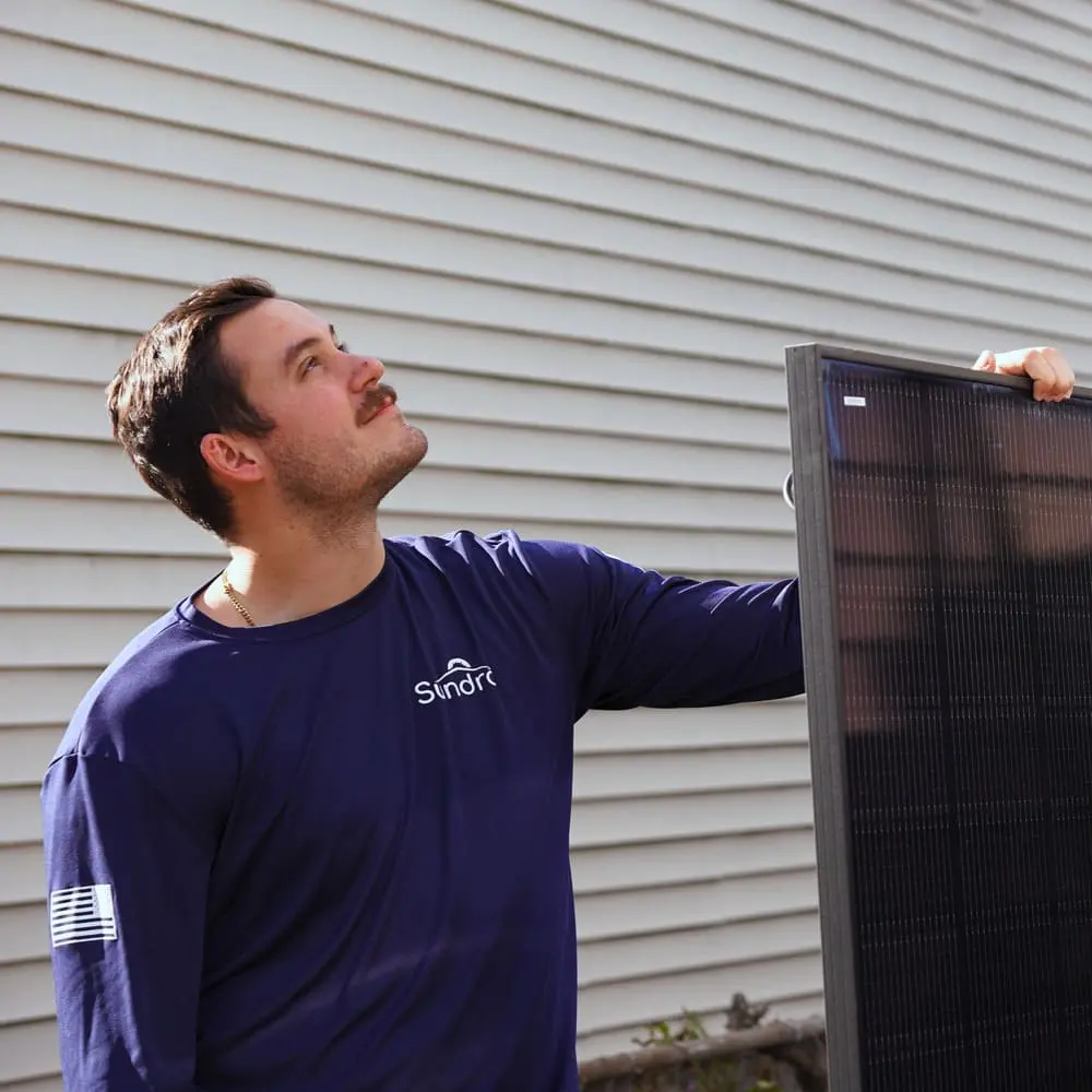 Commercial solar technician assessing roof condition for a roof-integrated solar installation