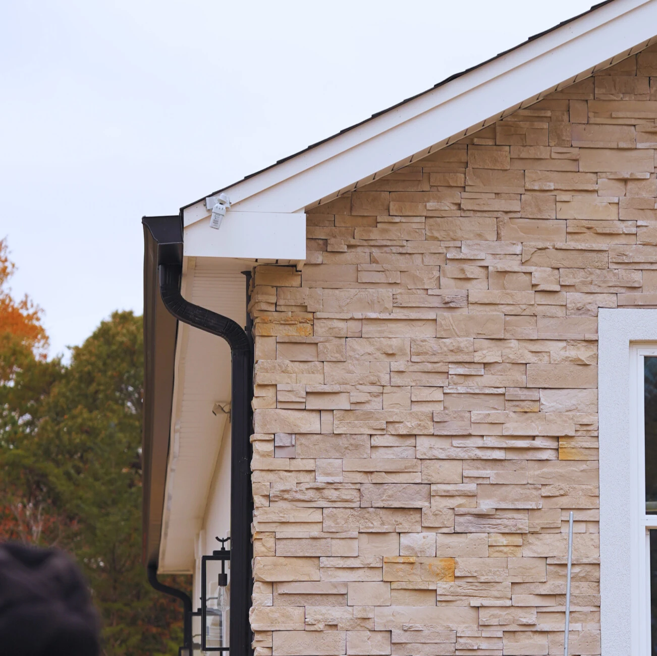 Close-up of new black gutters on a residential home