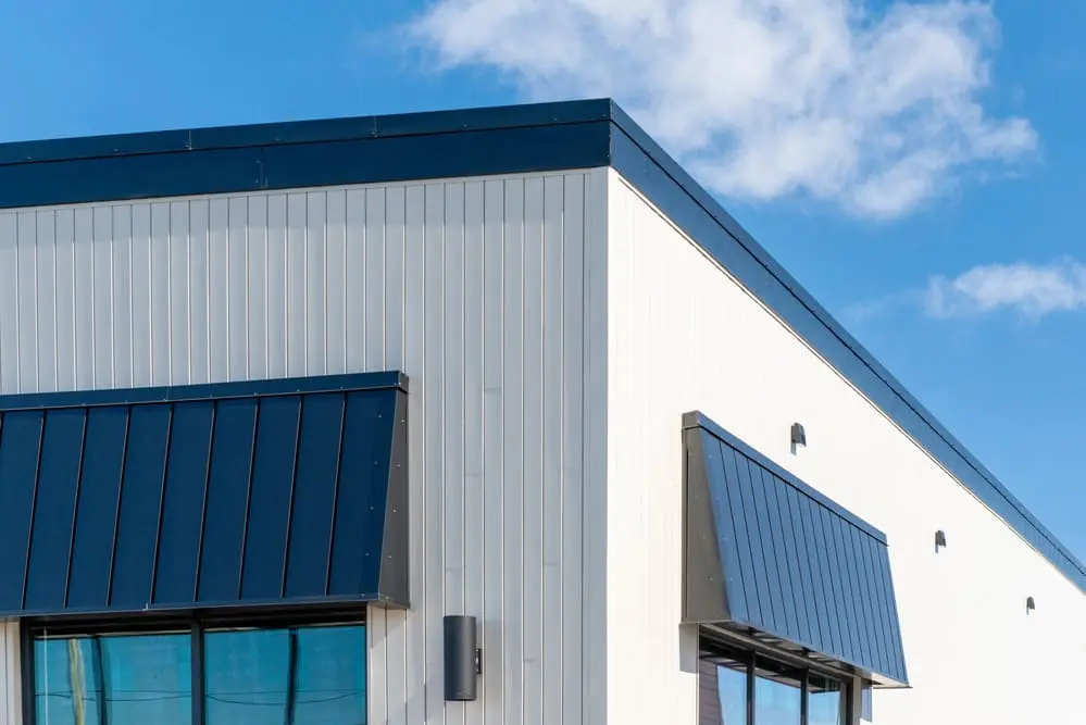 Commercial building exterior featuring metal siding systems with vertical steel panels designed for durable and low-maintenance commercial siding applications
