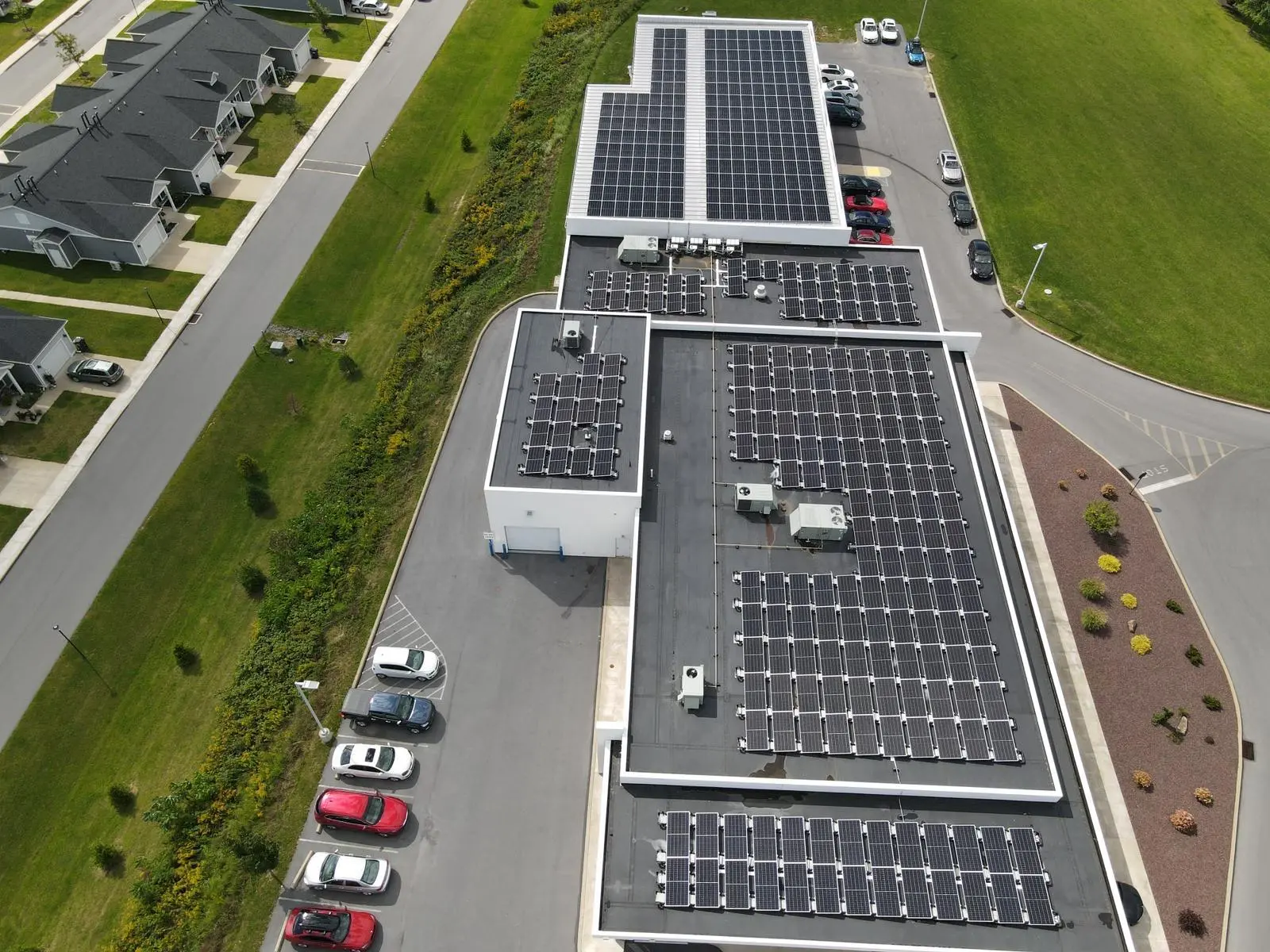 Rooftop solar arrays installed across an auto dealership campus