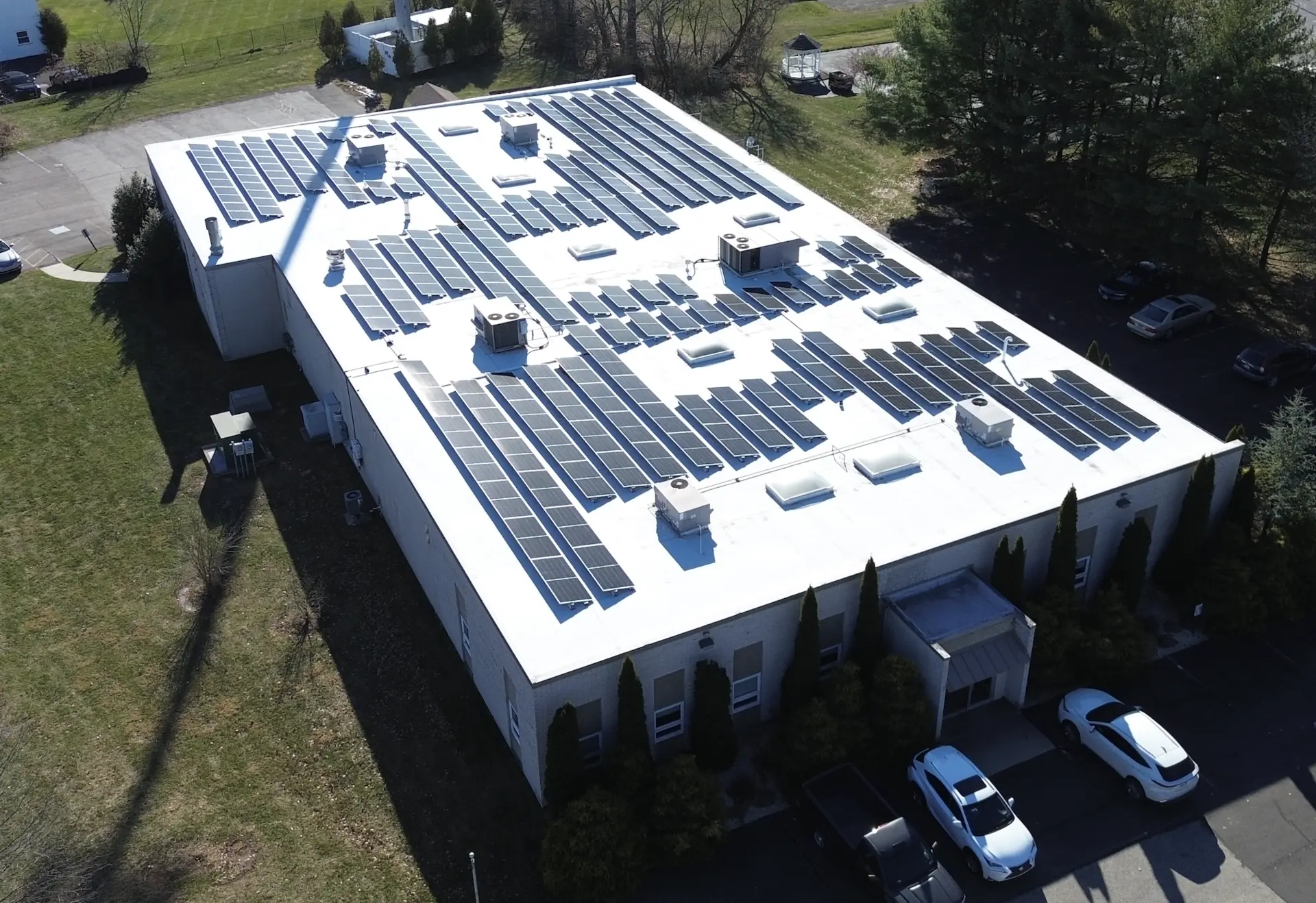 Commercial building with a full rooftop solar array on a white membrane roof