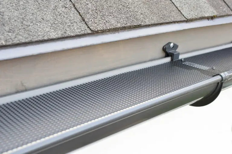solid surface gutter protection installed on a residential gutter to direct rainwater inside while leaves and debris slide off